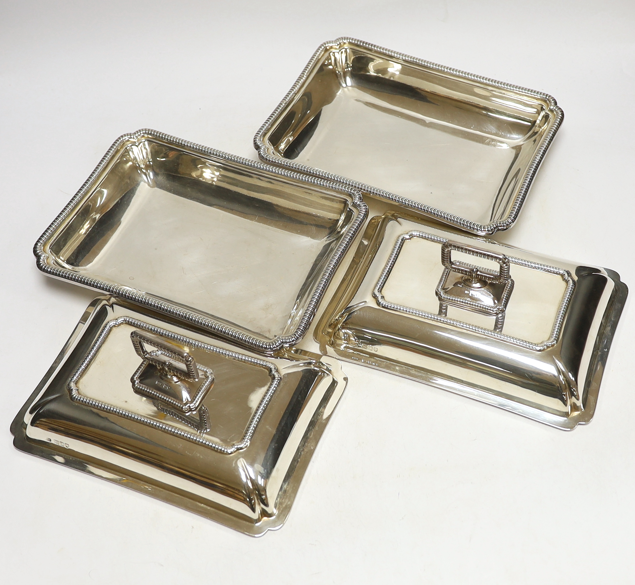 A pair of George V silver rectangular entrée dishes with covers and handles, by George Howson